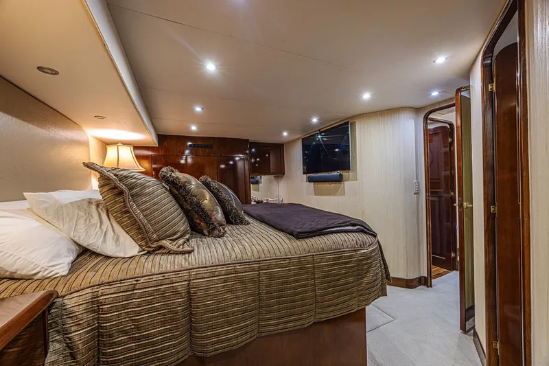Slide: The Image of Luxurious bedroom interior of 2005 Ocean Yachts 73 Super Sport with elegant bedding and ambient lighting. - 25