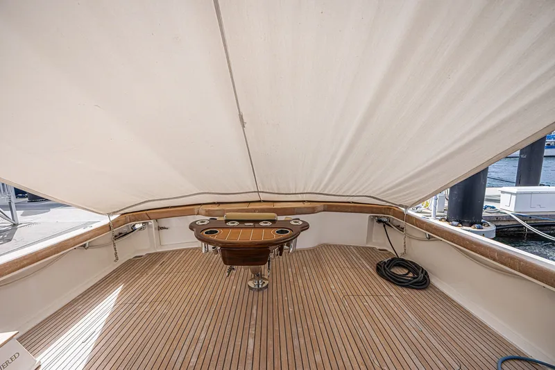 Slide: The Image of Spacious deck of 2005 Ocean Yachts 73 Super Sport with wooden flooring and covered seating area. - 34