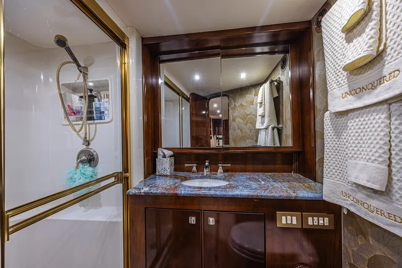 Slide: The Image of Luxurious bathroom in 2005 Ocean Yachts 73 Super Sport with elegant wood and marble finishes. - 26