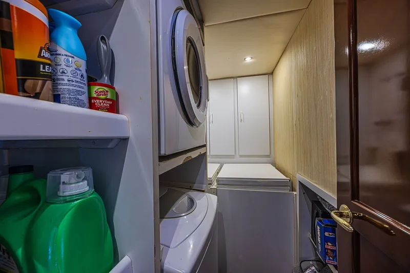 Slide: The Image of Laundry area on 2005 Ocean Yachts 73 Super Sport with stacked washer and dryer. - 22
