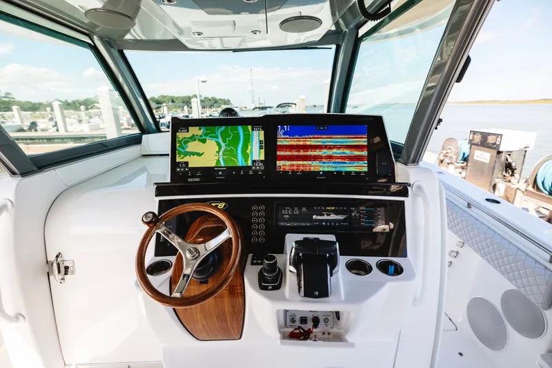 Slide: The Image of Helm of 2026 HCB 48 Campeón boat with advanced navigation displays and controls. - 48