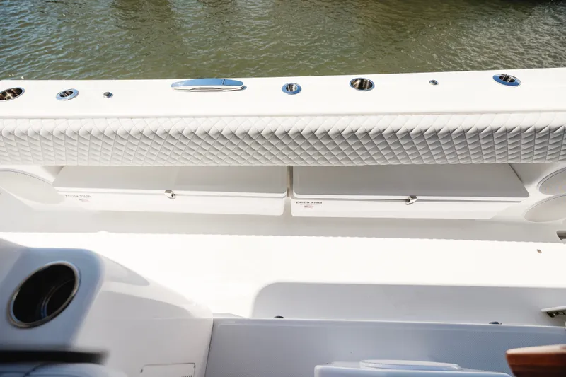 Slide: The Image of 2026 HCB 48 Campeón boat interior with quilted seating and storage compartments. - 20
