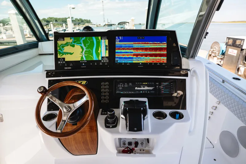 Slide: The Image of Helm of 2026 HCB 48 Campeón boat with advanced navigation displays and controls. - 47