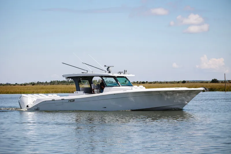 The Image of 2026 HCB 48 Campeón boat cruising on calm waters under a clear sky. - 1