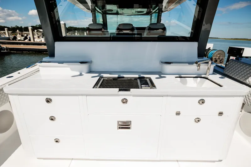 Slide: The Image of Luxury outdoor kitchen on 2026 HCB 48 Campeón yacht with grill and sink. - 54