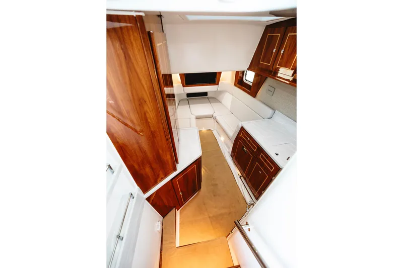 Slide: The Image of Luxurious interior of 2026 HCB 48 Campeón yacht with elegant wood cabinetry and white seating. - 41