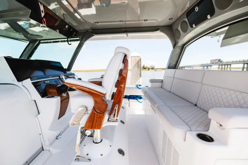 Slide: The Image of Luxurious interior of 2026 HCB 48 Campeón boat with plush seating and modern helm. - 18