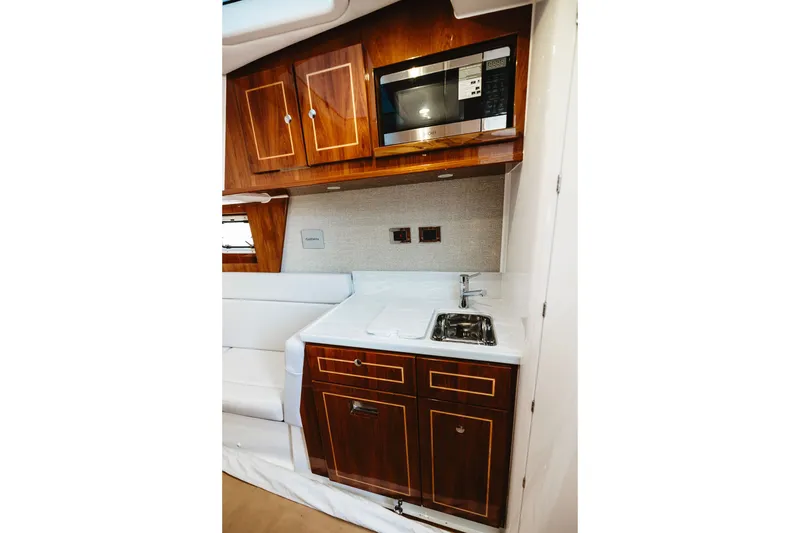 Slide: The Image of Luxurious kitchenette in 2026 HCB 48 Campeón boat with wood cabinets and modern appliances. - 26