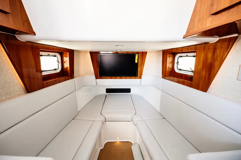 Slide: The Image of Luxurious interior of 2026 HCB 48 Campeón yacht with white seating and wood accents. - 21