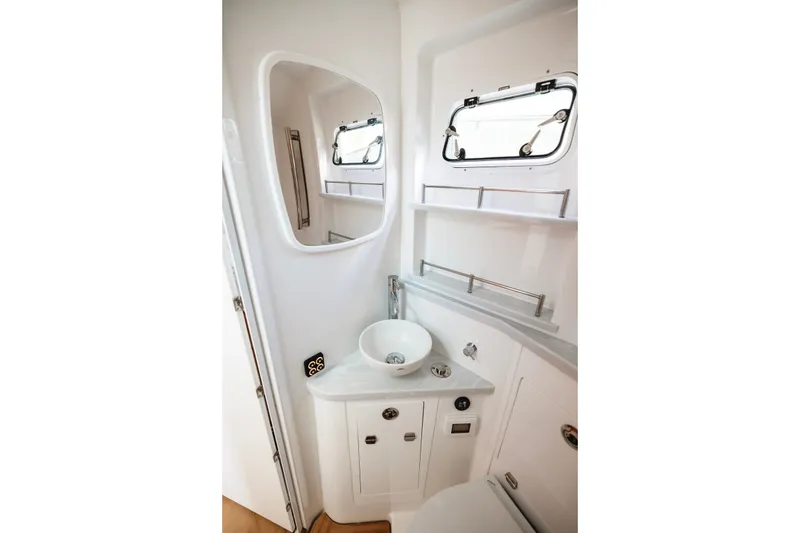 Slide: The Image of Compact bathroom interior of 2026 HCB 48 Campeón boat with sink and mirror. - 31