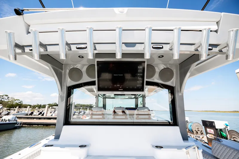 Slide: The Image of 2026 HCB 48 Campeón boat dashboard with modern electronics and rod holders. - 52