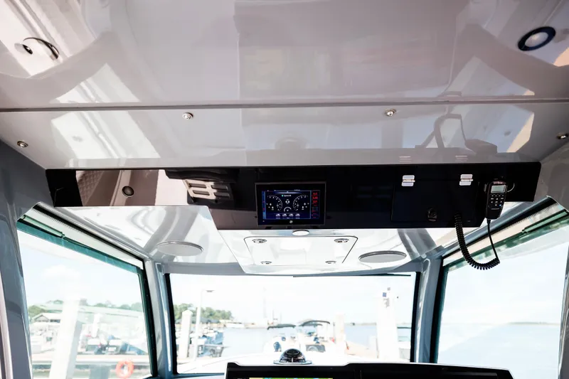 Slide: The Image of Interior view of 2026 HCB 48 Campeón boat cockpit with control panel and radio. - 51
