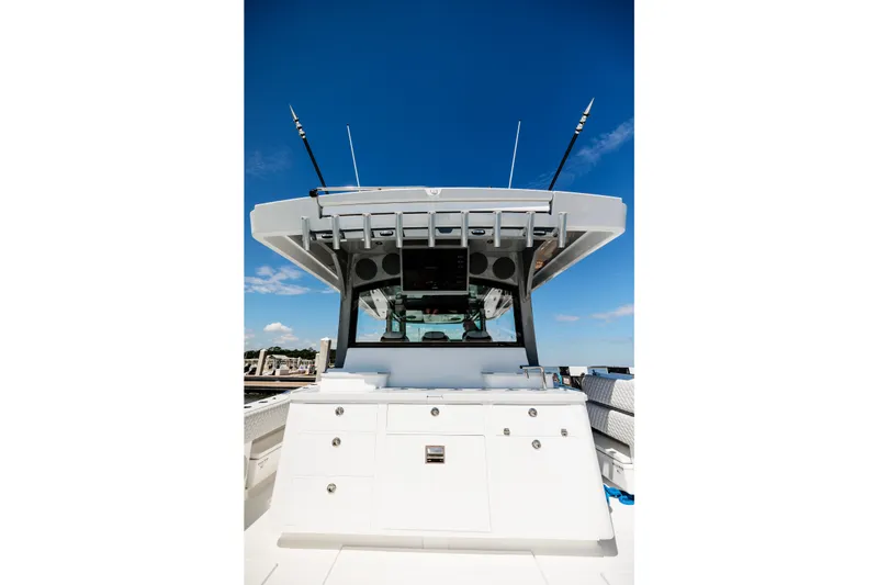 Slide: The Image of 2026 HCB 48 Campeón boat helm with antennas against clear blue sky. - 53