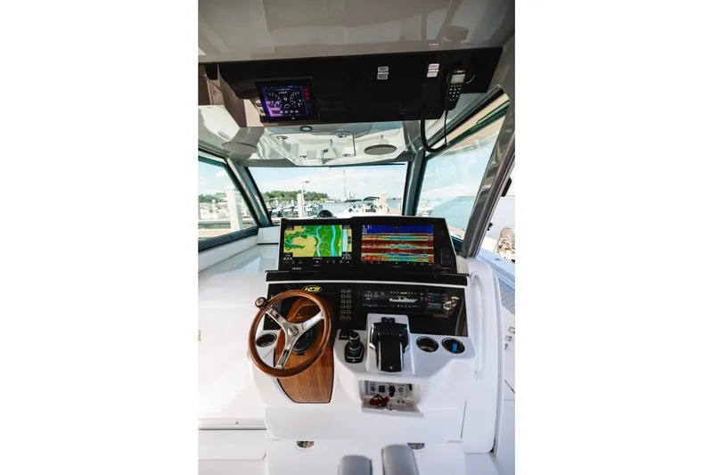 Slide: The Image of Helm of 2026 HCB 48 Campeón boat with advanced navigation displays and controls. - 49