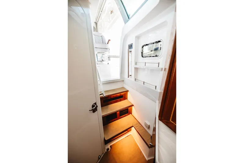 Slide: The Image of Interior stairs of 2026 HCB 48 Campeón boat, featuring modern design and lighting. - 40