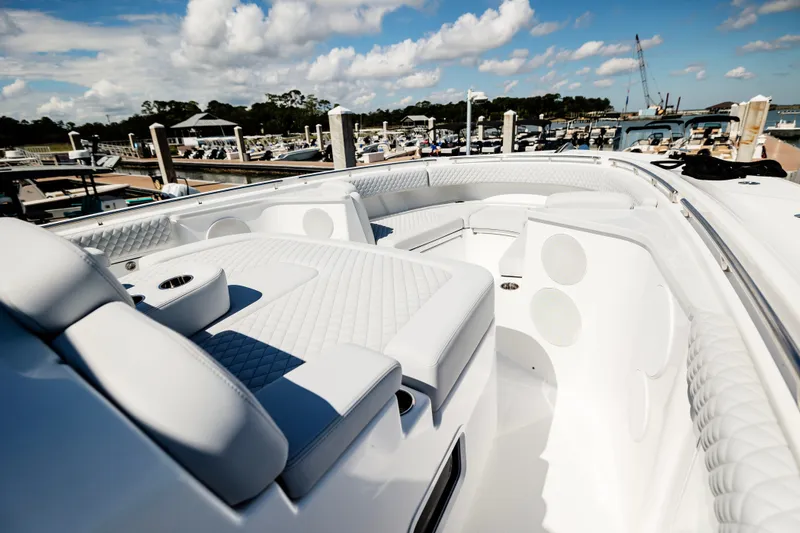 Slide: The Image of Luxurious 2026 HCB 48 Campeón boat interior with plush seating at marina. - 14