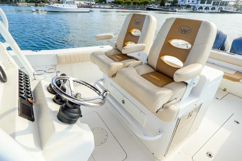 Slide: The Image of 2015 Southport 33 FE boat interior with dual helm seats and steering wheel. - 4