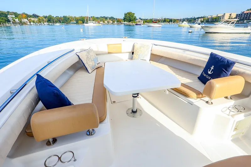 Slide: The Image of Luxurious seating area on a 2015 Southport 33 FE boat, with scenic waterfront view. - 12