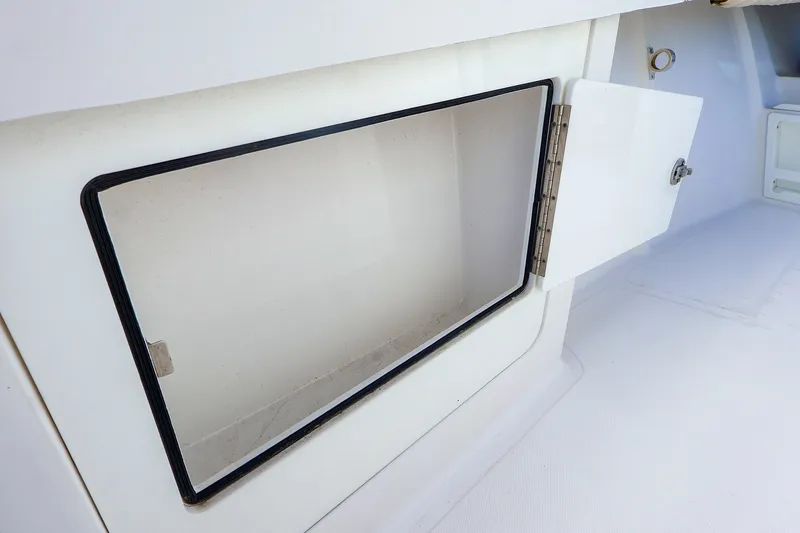 Slide: The Image of Open storage compartment on a 2015 Southport 33 FE boat. - 21