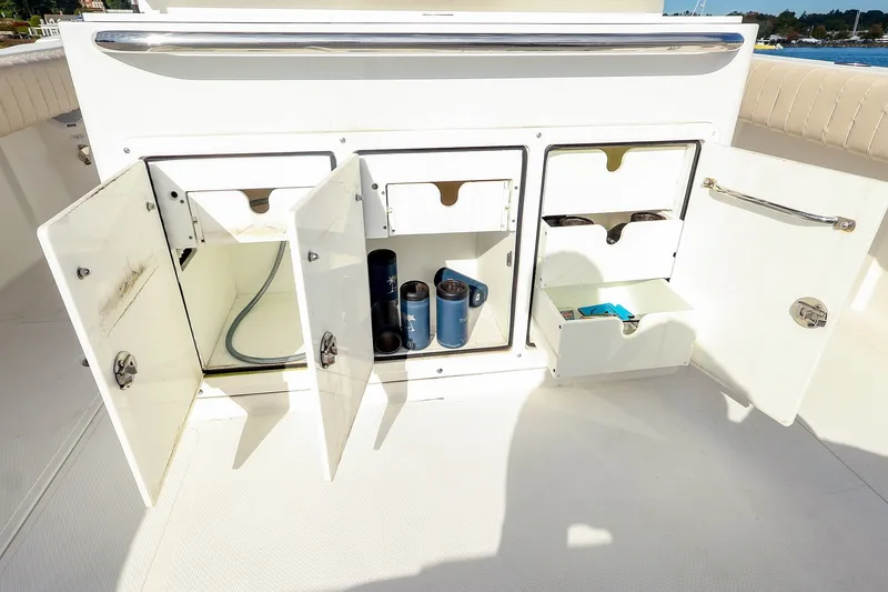 Slide: The Image of Open storage compartments on a 2015 Southport 33 FE boat, showcasing interior organization. - 29