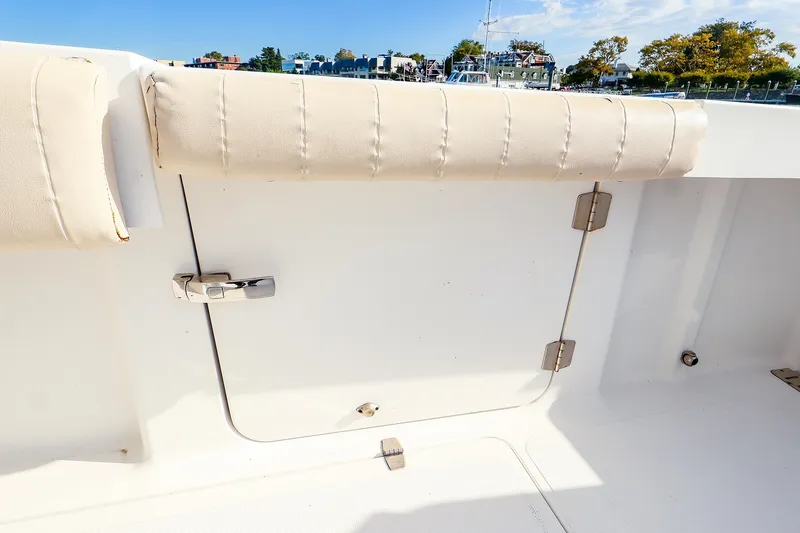 Slide: The Image of 2015 Southport 33 FE boat interior with cushioned seating and storage compartment. - 25
