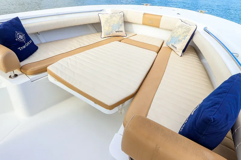 Slide: The Image of Luxurious seating area on a 2015 Southport 33 FE boat with nautical-themed cushions. - 14