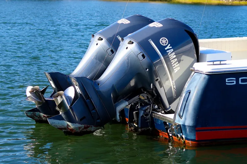 Slide: The Image of Twin Yamaha outboard motors on a 2015 Southport 33 FE boat in water. - 37