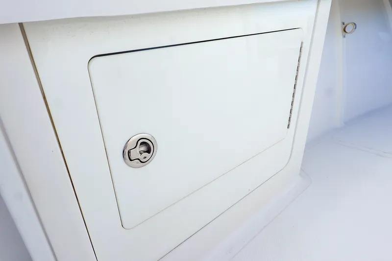 Slide: The Image of Storage compartment on a 2015 Southport 33 FE boat, featuring a secure latch. - 20