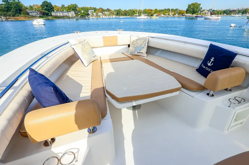 Slide: The Image of Luxurious seating area on a 2015 Southport 33 FE boat with scenic waterfront view. - 13