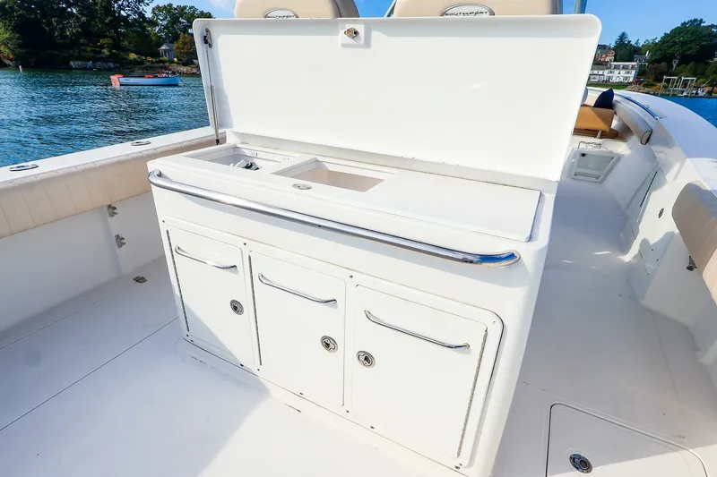 Slide: The Image of 2015 Southport 33 FE boat with open storage compartments on deck. - 27