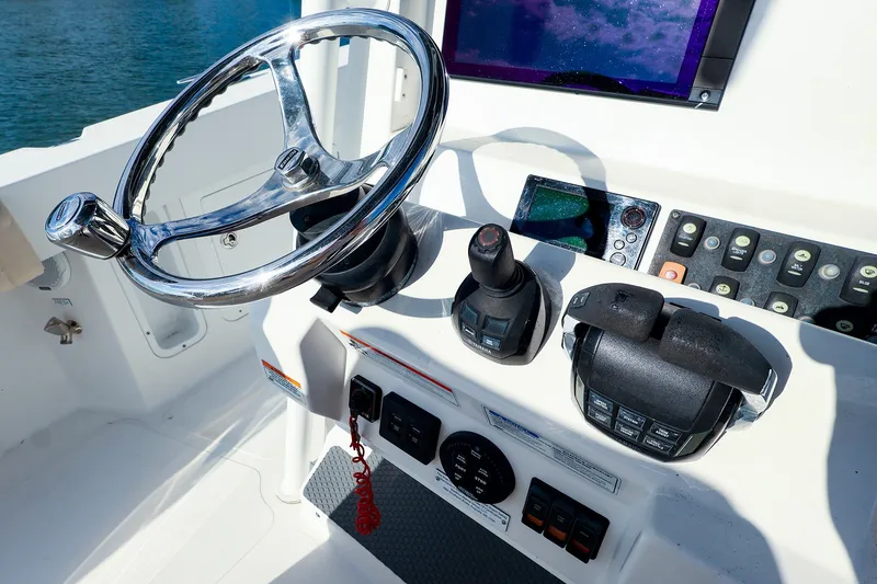 Slide: The Image of Steering console of a 2015 Southport 33 FE boat with controls and display. - 5