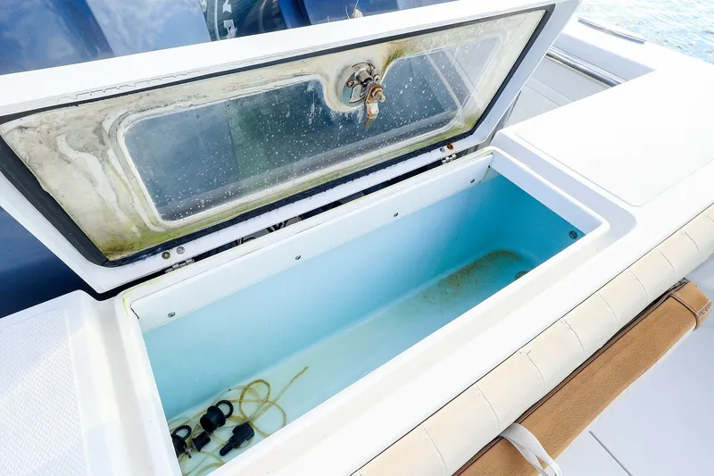 Slide: The Image of Open storage compartment on 2015 Southport 33 FE boat, showing interior details. - 31