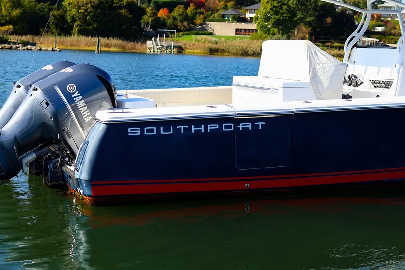 Slide: The Image of 2015 Southport 33 FE boat with Yamaha engines on a scenic waterway. - 1