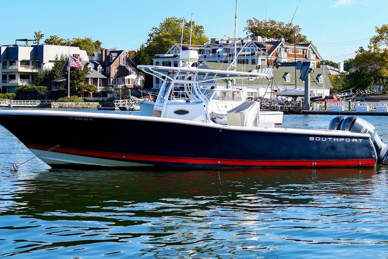 Slide: The Image of 2015 Southport 33 FE boat docked near waterfront homes. - 38
