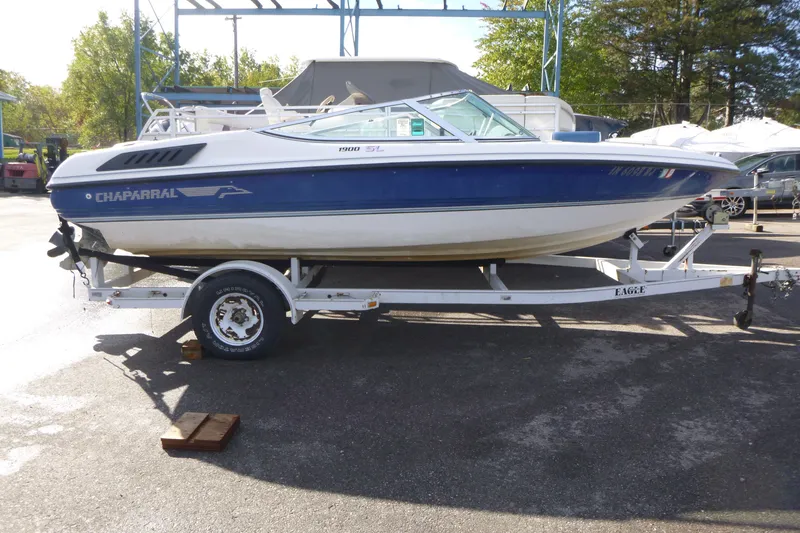 The Image of 1992 Chaparral boat on trailer, blue and white, parked outdoors. - 0