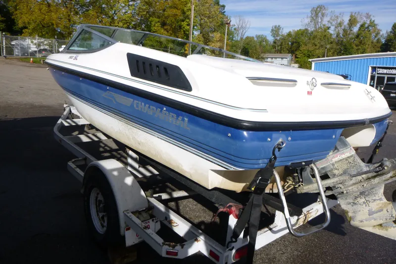 Slide: The Image of 1992 Chaparral boat on trailer, blue and white, parked outdoors. - 4
