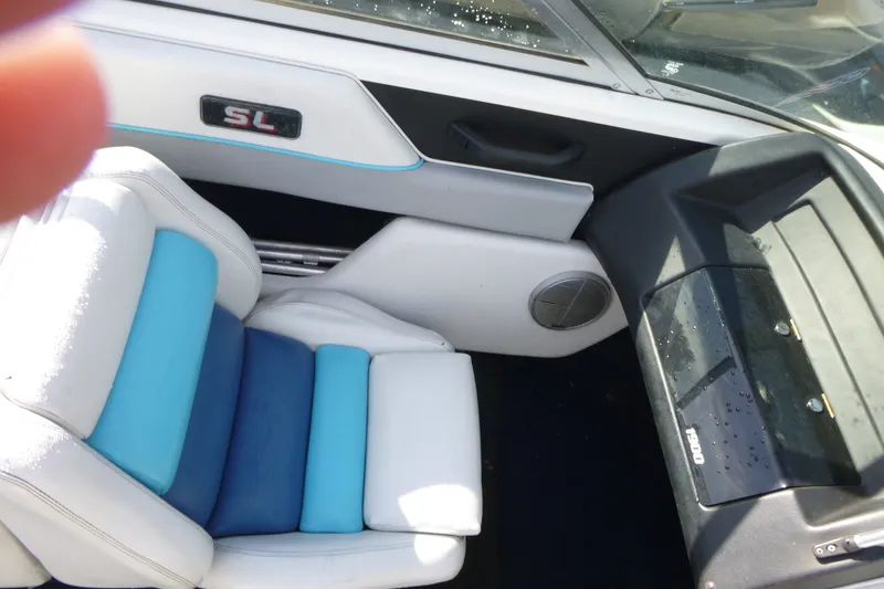 Slide: The Image of Interior of a 1992 Chaparral boat featuring blue and white seating and dashboard details. - 9
