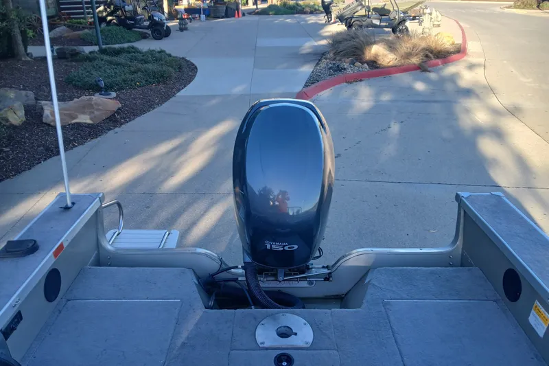 Slide: The Image of 2005 G3 Angler V175 FS boat with Yamaha 150 outboard motor on a paved driveway. - 5
