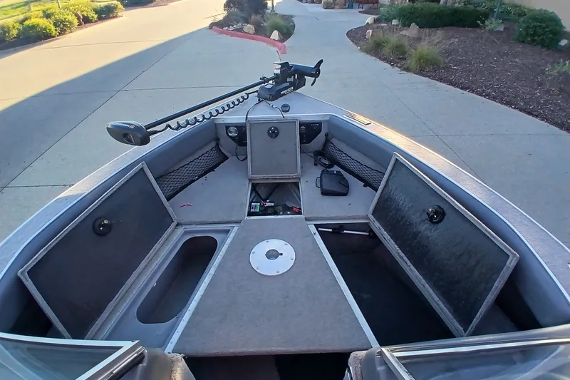 Slide: The Image of 2005 G3 Angler V175 FS boat interior with open storage compartments and trolling motor. - 9