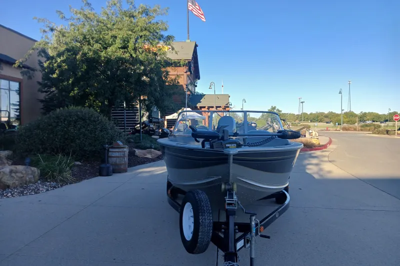 The Image of 2005 G3 Angler V175 FS boat on trailer, parked outdoors near a building. - 0