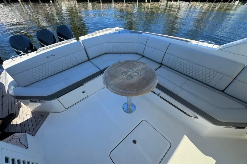Slide: The Image of The image shows the stern of a Sea Ray SLX 400 Outboard with an elegant seating area and round table. - 16