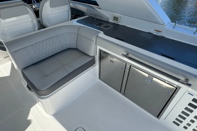 Slide: The Image of The 2021 Sea Ray SLX 400 Outboard features a sleek seating area and modern kitchenette. - 35