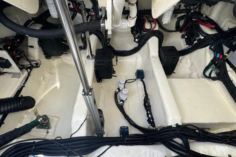 Slide: The Image of The engine compartment of a 2021 Sea Ray SLX 400 Outboard with cables and hoses. - 41