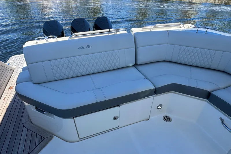 Slide: The Image of The 2021 Sea Ray SLX 400 Outboard features a luxurious, cushioned seating area at the stern. - 27