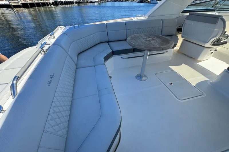 Slide: The Image of The image shows the cockpit of a 2021 Sea Ray SLX 400 Outboard with elegant seating arrangement. - 17