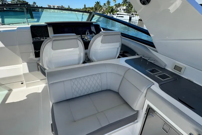 Slide: The Image of The image shows the cockpit of a 2021 Sea Ray SLX 400 Outboard with luxurious seating. - 36