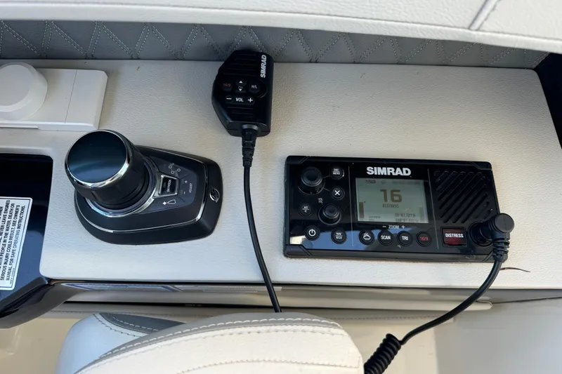 Slide: The Image of The image shows the helm console of a Sea Ray SLX 400 Outboard with Simrad equipment. - 13