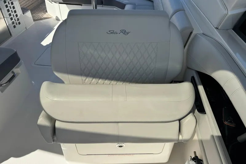 Slide: The Image of A luxurious seat in the 2021 Sea Ray SLX 400 Outboard, featuring quilted leather and armrest. - 14