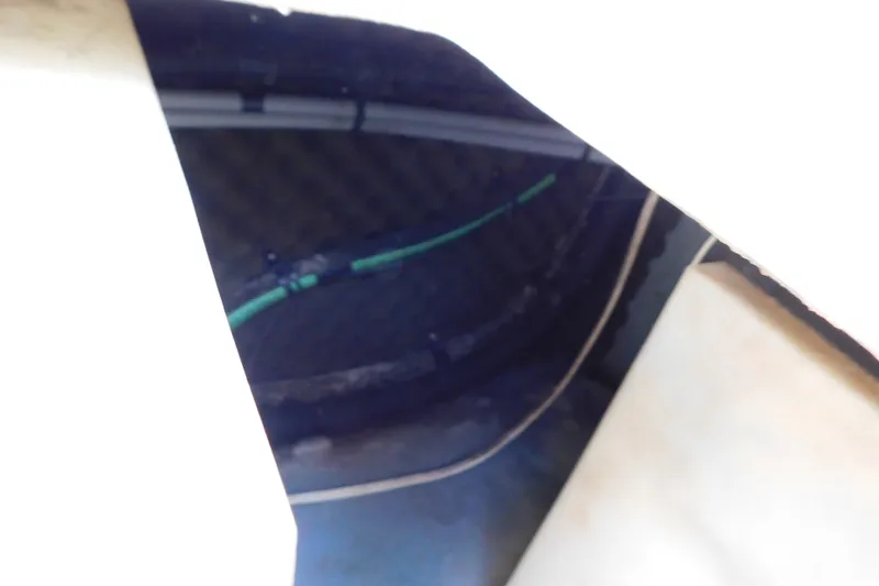 Slide: The Image of Interior view of a 1996 Sea Ray 250 Sundancer boat, showing wiring and structural details. - 86