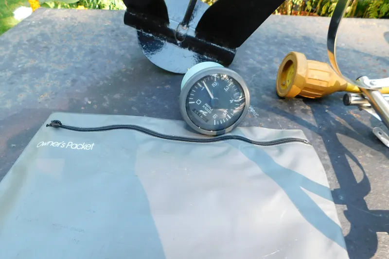 Slide: The Image of Owner's packet and gauge for 1996 Sea Ray 250 Sundancer boat on table. - 98